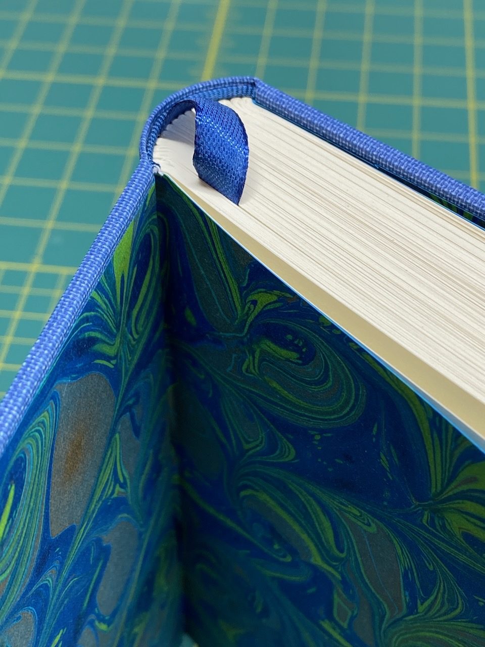Marbled endpapers and a sewn headband inside a finished binding