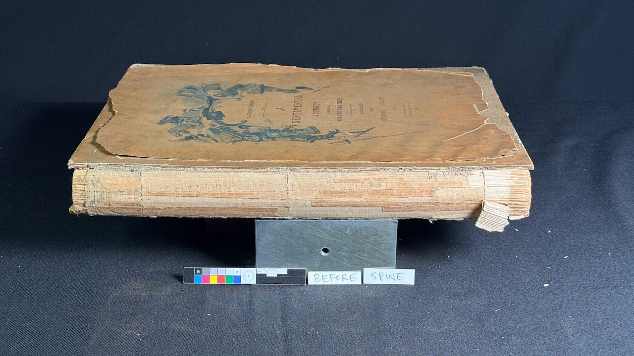 Fragile cloth-bound volume with lifted covering material before treatment
