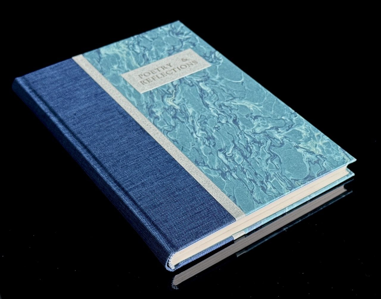Navy cloth binding with pale blue marbled panel and printed paper label