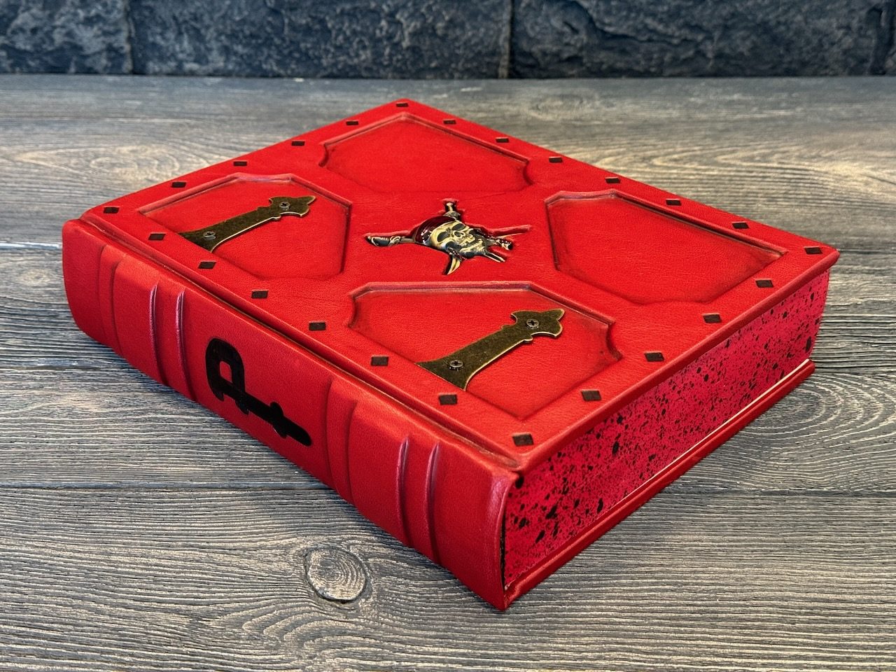 Red leather book cover with decorative blind tooling and metal fittings