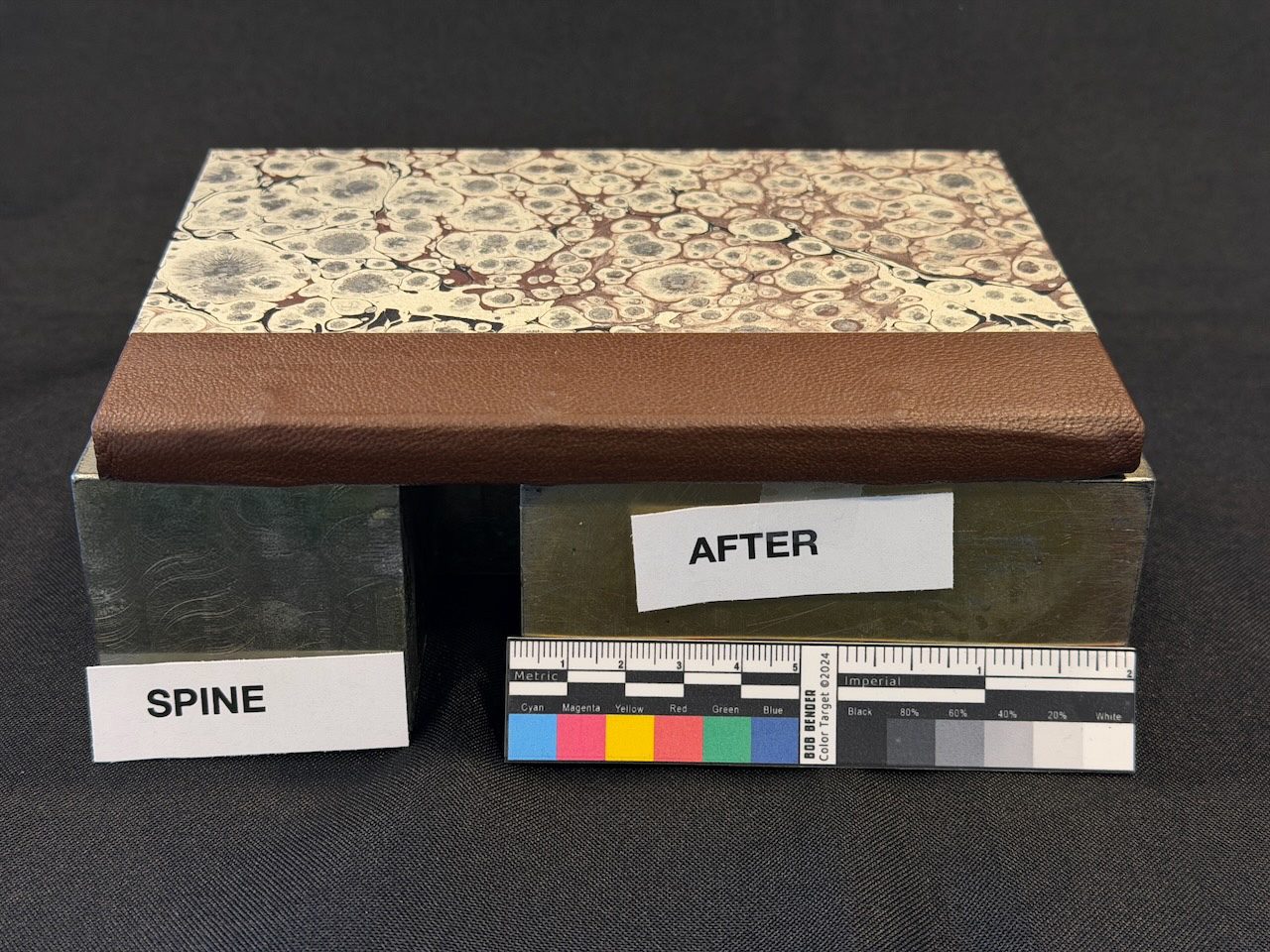 The same book after restoration with rebuilt spine and marbled boards